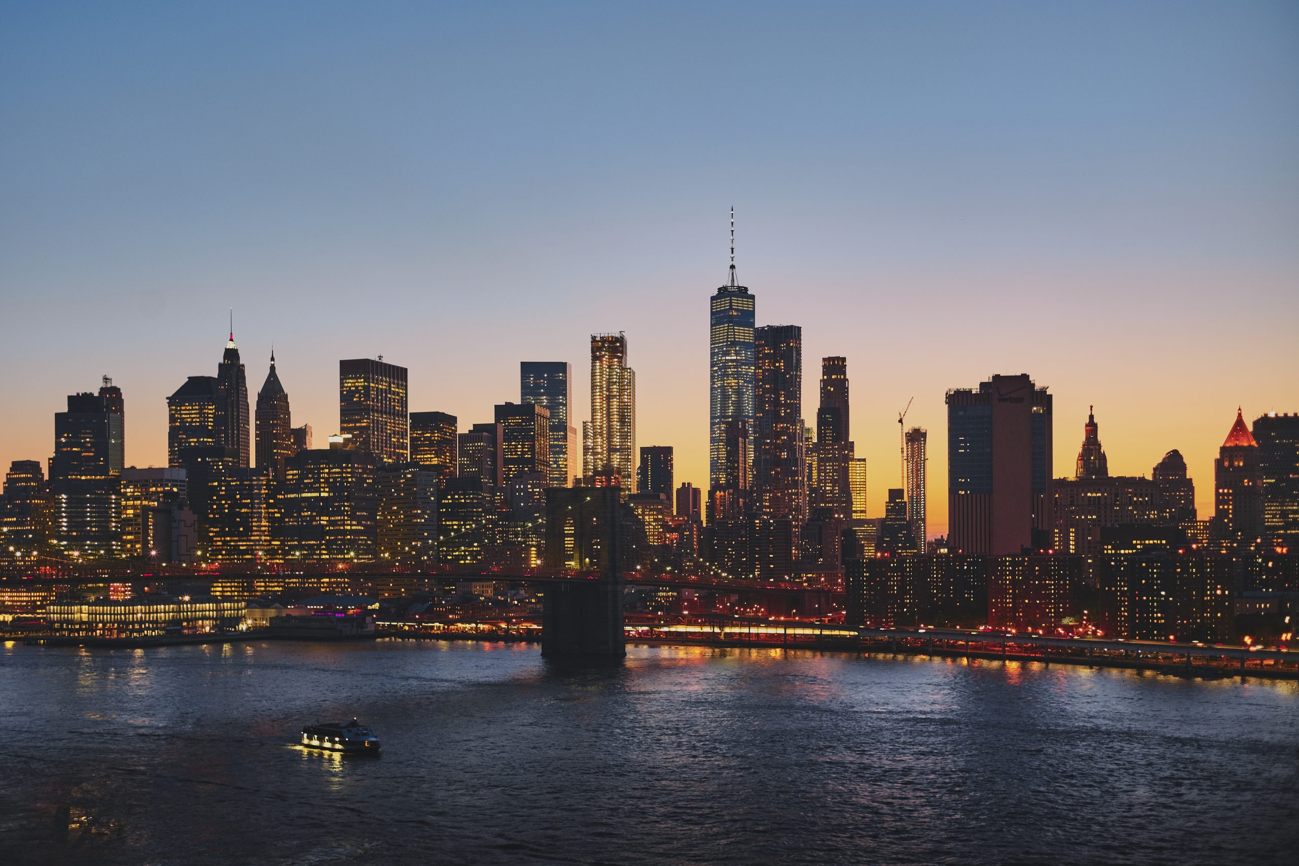 Horizontal shot of New York cityscape, with the Brooklyn Bridge over the East River in the shot